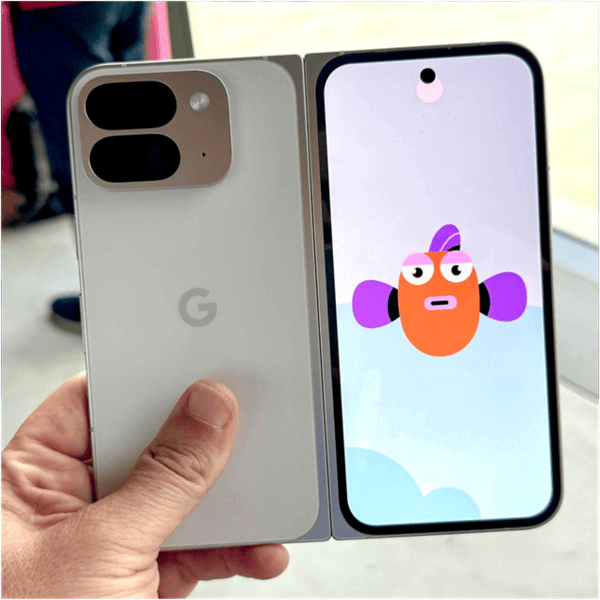 Google Pixel 9 Pro Fold smartphone unfolded, showcasing its dual rear cameras and foldable display with a cartoon fish on screen.